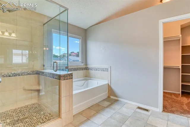 a bathroom with a bathtub and a shower