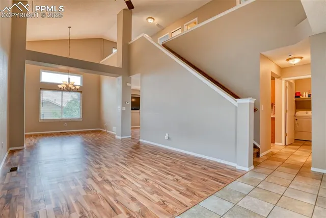 a view of a hallway with wooden floor and entryway