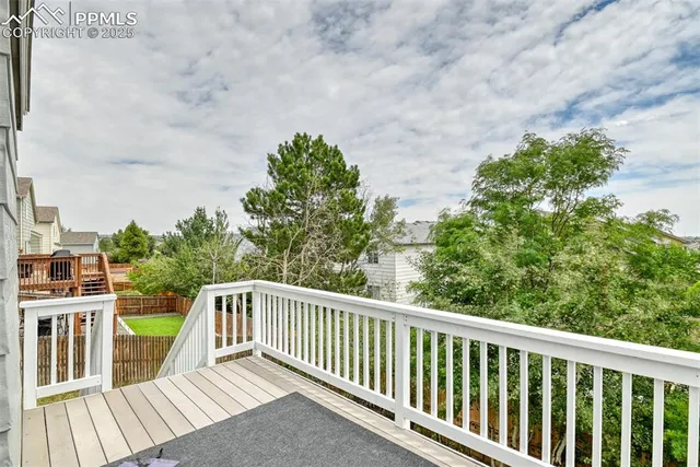 a balcony with wooden floor and fence
