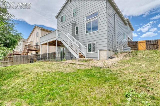 a view of a house with a yard and sitting area