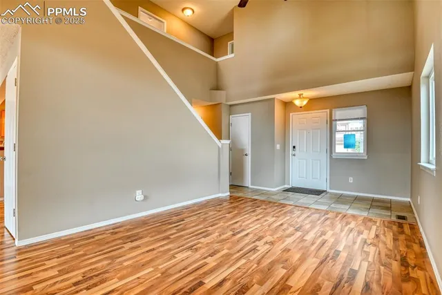 a view of an empty room with wooden floor