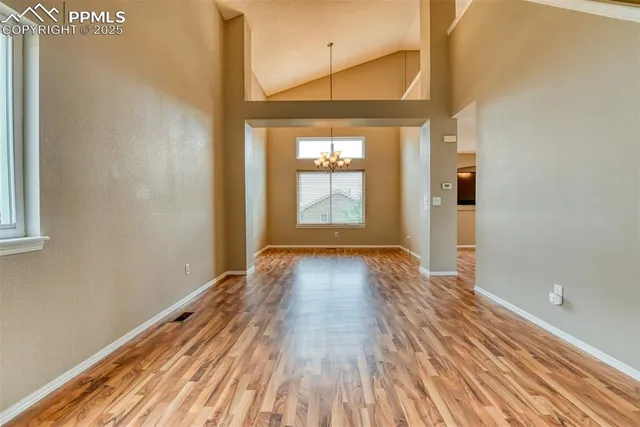 a view of a room with wooden floor and window