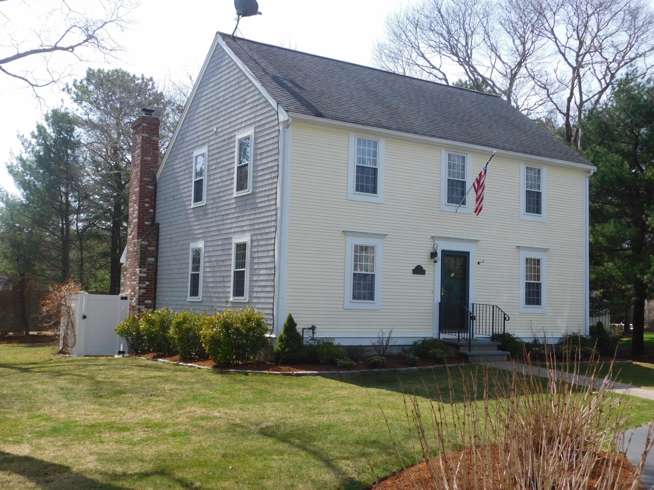 17 Captain Carltons Road Cotuit, MA 02635 - Photo 1 of 26 a front view of a house with a lake view