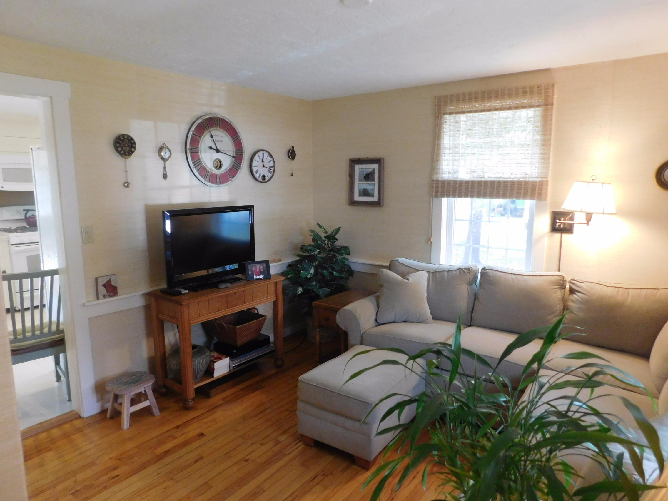 17 Captain Carltons Road Cotuit, MA 02635 - Photo 15 of 26 a living room with furniture a flat screen tv and a fireplace