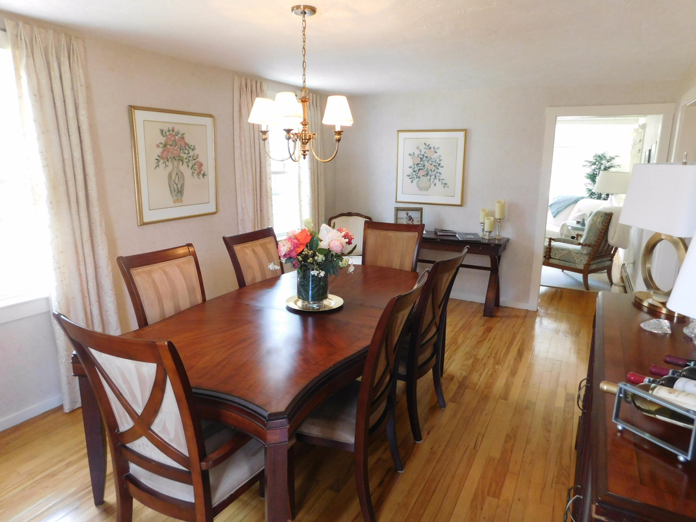 17 Captain Carltons Road Cotuit, MA 02635 - Photo 17 of 26 a view of a dining room with furniture wooden floor and a chandelier