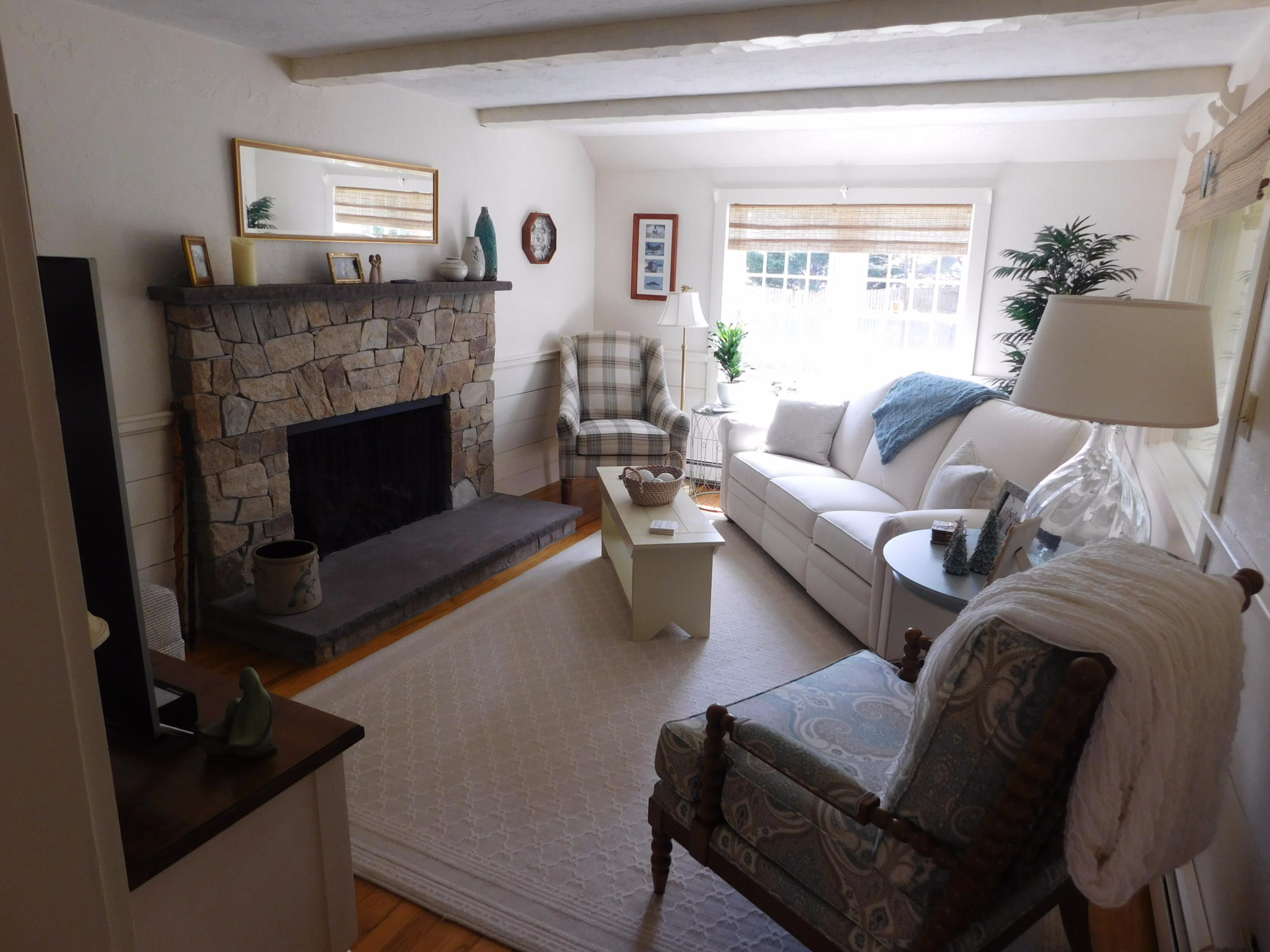 17 Captain Carltons Road Cotuit, MA 02635 - Photo 18 of 26 a living room with furniture and a fireplace