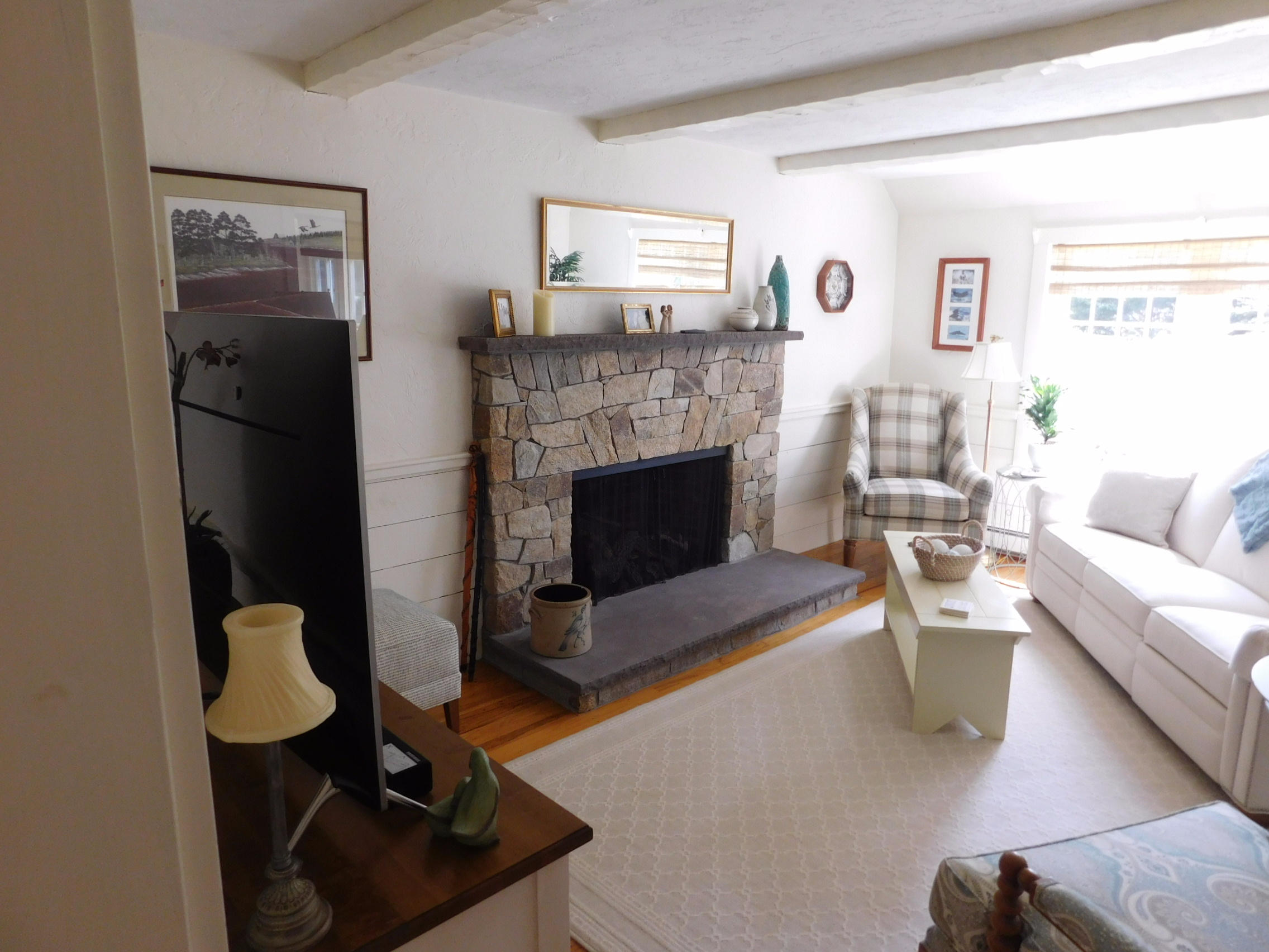 17 Captain Carltons Road Cotuit, MA 02635 - Photo 19 of 26 a living room with furniture and a fireplace