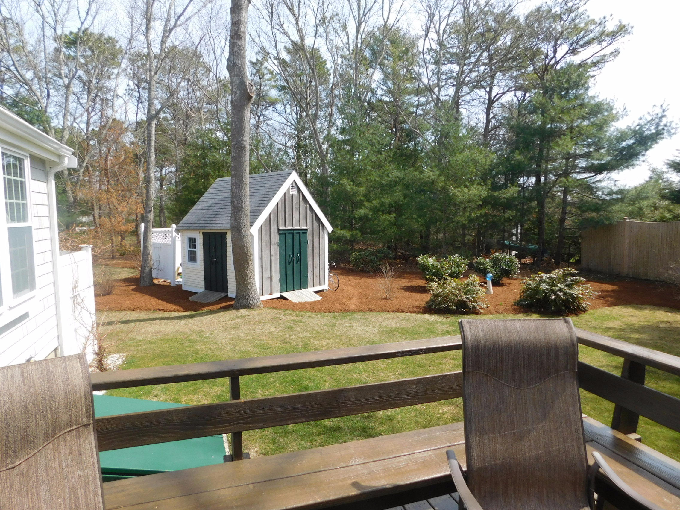 17 Captain Carltons Road Cotuit, MA 02635 - Photo 4 of 26 a view of a white house with wooden fence