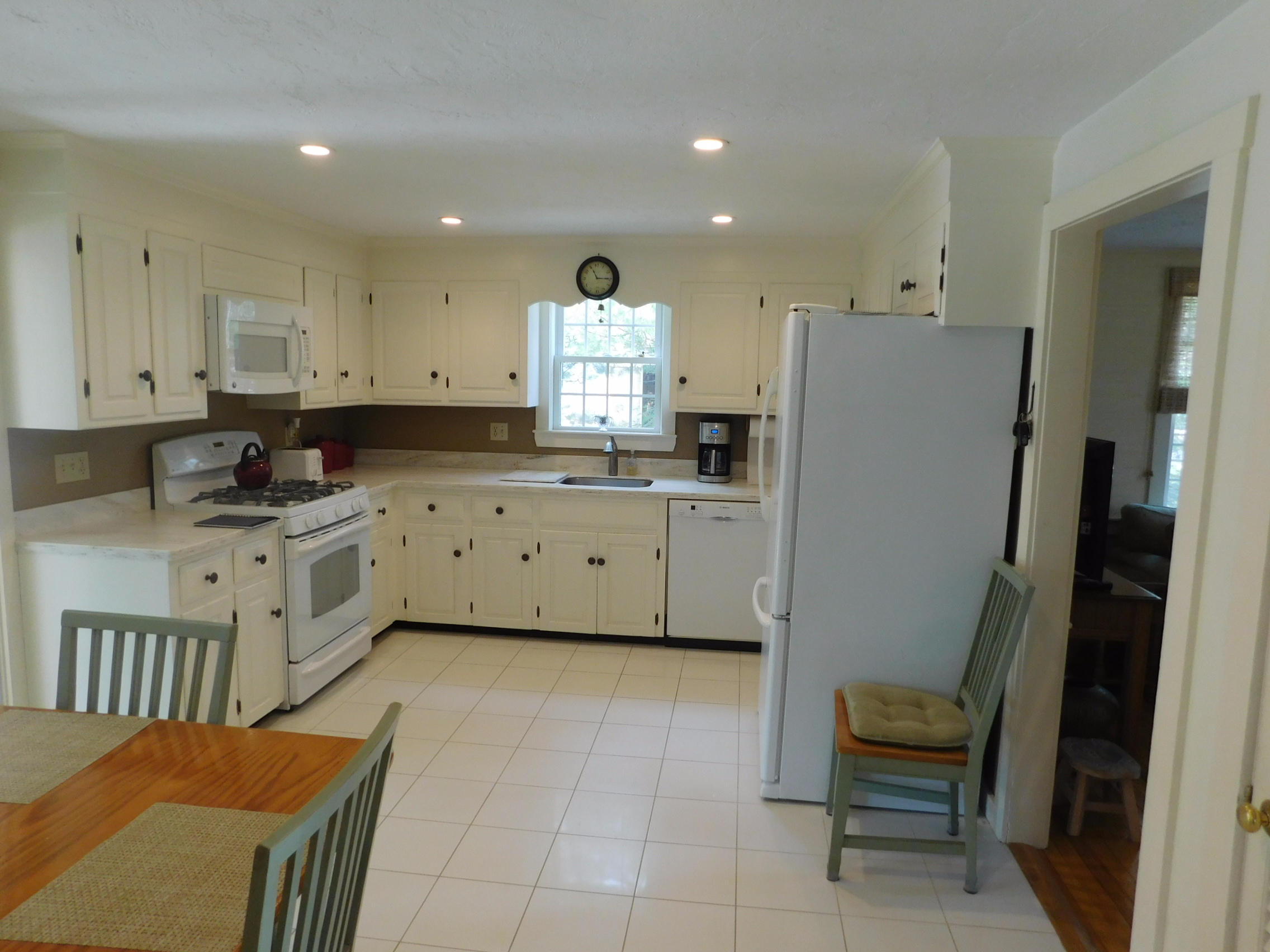 17 Captain Carltons Road Cotuit, MA 02635 - Photo 9 of 26 a kitchen with white cabinets and sink