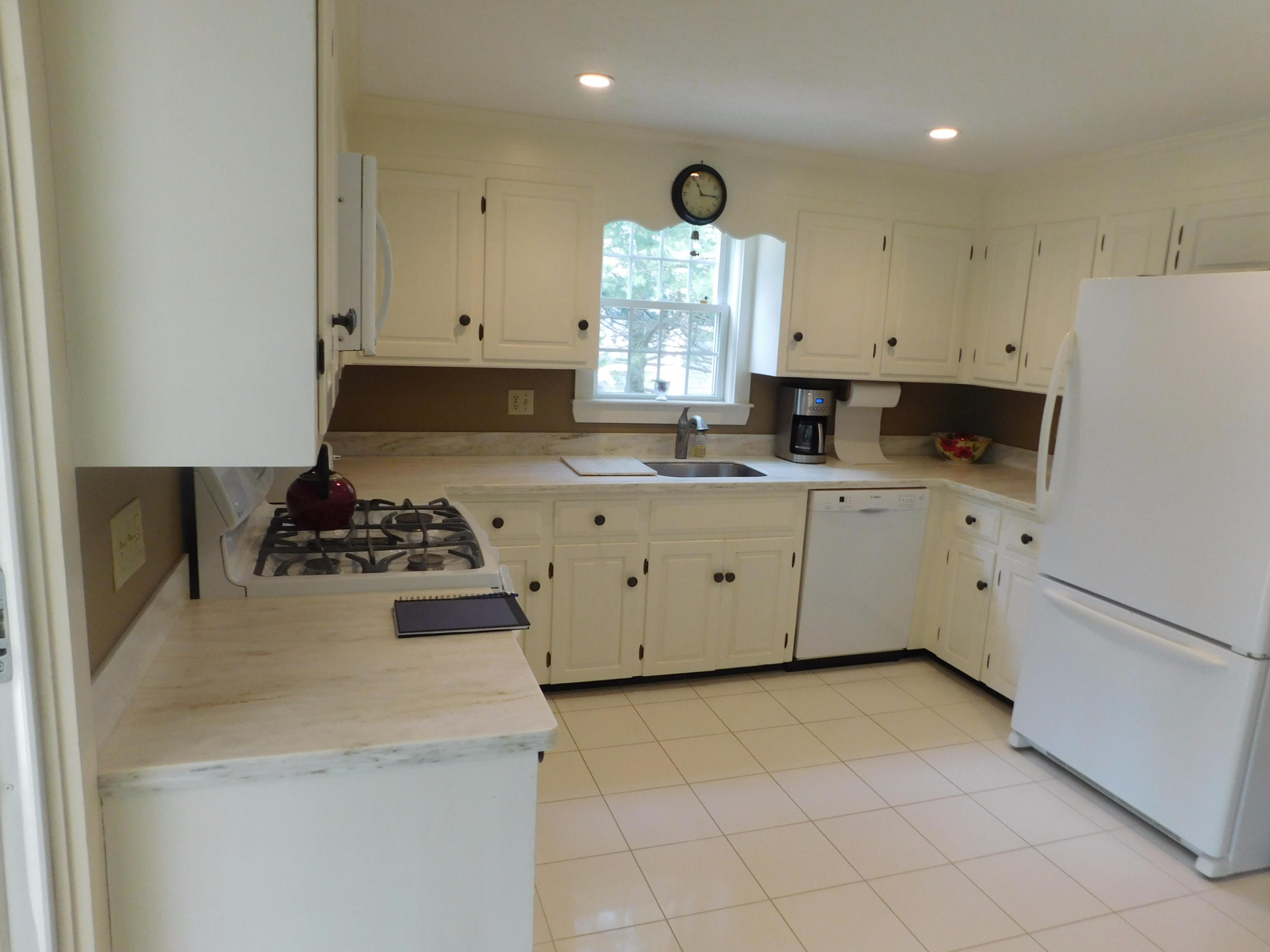 17 Captain Carltons Road Cotuit, MA 02635 - Photo 10 of 26 a kitchen with a sink a stove and cabinets
