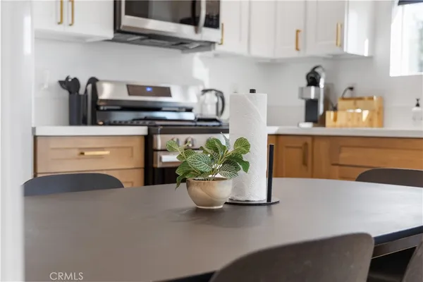 a kitchen with a stove and a white cabinets