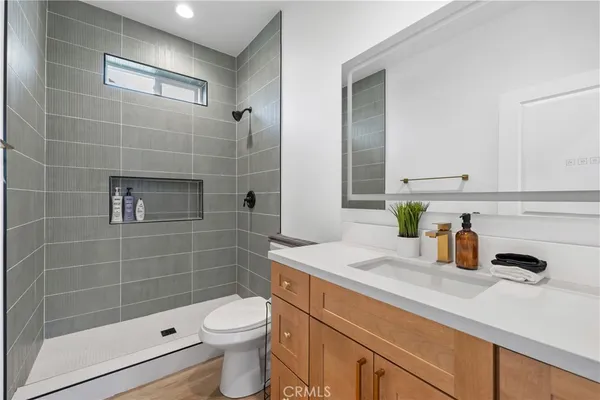 a bathroom with a sink a toilet and shower