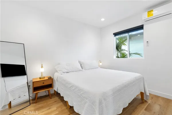 a bedroom with a bed and a couch