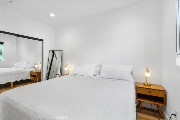 a bedroom with a bed and wooden floor