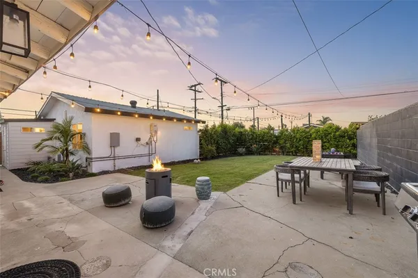 a view of a patio with chairs and plants