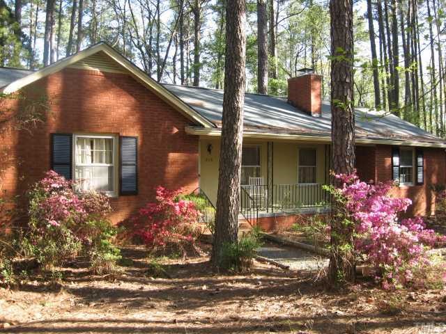 3115 Ridge Road Durham, NC 27705 - Photo 1 of 12 Wonderful One Level Home on 1.8 acres of bling in Perfect location. Gardens, paths, greenhouse, garage could be great family room or studio.