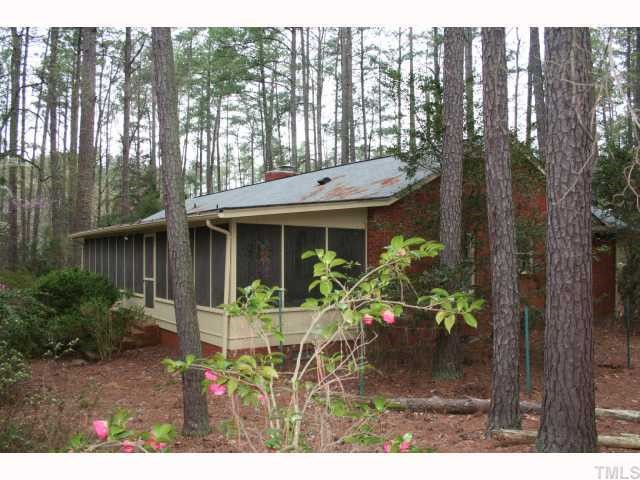 3115 Ridge Road Durham, NC 27705 - Photo 2 of 12 Wonderful screened porch is 42' long and overlooks almost 2 acres of planted privacy and bliss. Enjoy this porch almost year-round.