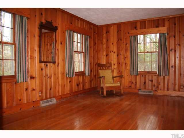 3115 Ridge Road Durham, NC 27705 - Photo 7 of 12 Master bedroom has warm pine paneling, hardwood floors, real cedar closets, real wood doors, a retro bathroom and access to the paneled garage. The other two bedrooms are at the entire opposite end of the house for great separation of space.