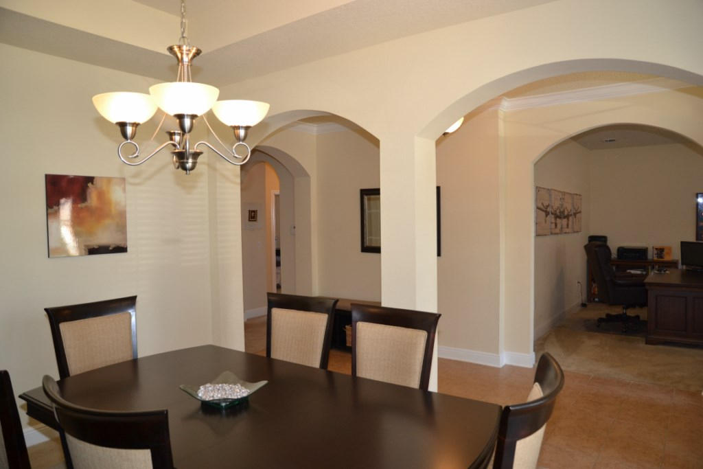 638 Red Fern Road Crestview, FL 32536 - Photo 11 of 55 a view of a dining room with furniture and wooden floor