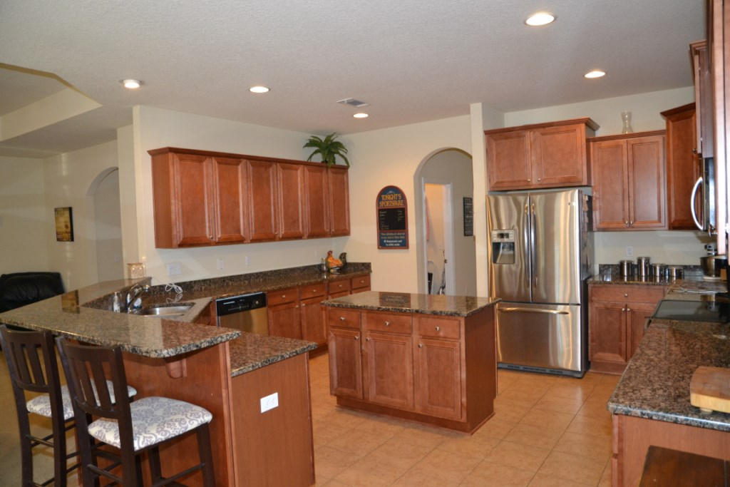 638 Red Fern Road Crestview, FL 32536 - Photo 20 of 55 a kitchen with stainless steel appliances granite countertop a refrigerator a sink a stove a dining table and chairs