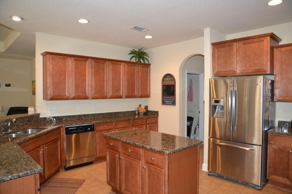 638 Red Fern Road Crestview, FL 32536 - Photo 22 of 55 a kitchen with stainless steel appliances granite countertop a refrigerator a sink and white cabinets