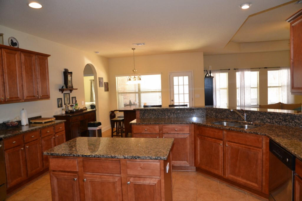638 Red Fern Road Crestview, FL 32536 - Photo 23 of 55 a kitchen with granite countertop a sink and cabinets