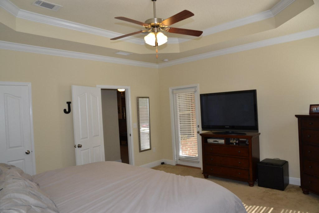 638 Red Fern Road Crestview, FL 32536 - Photo 27 of 55 a bedroom with a bed and a flat screen tv