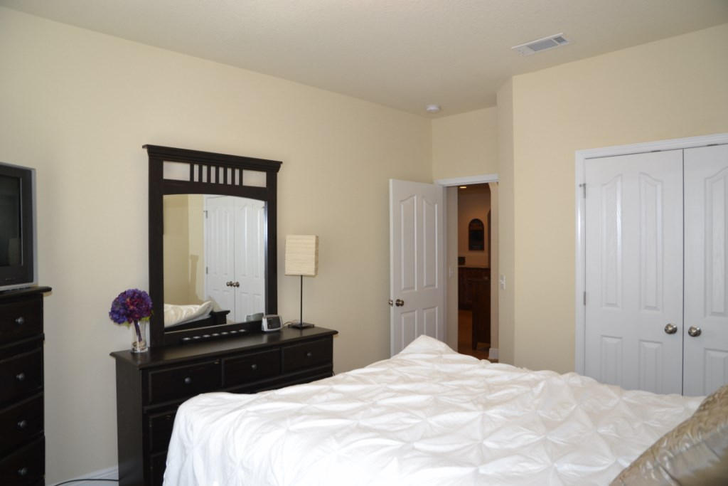 638 Red Fern Road Crestview, FL 32536 - Photo 34 of 55 a bedroom with a bed and a mirror