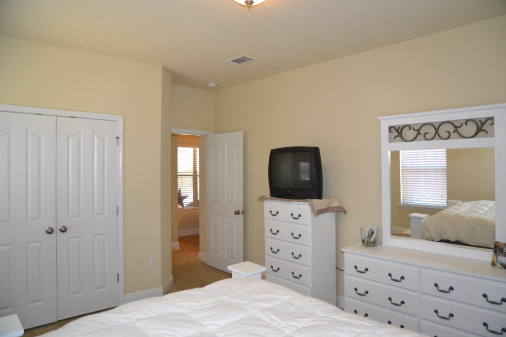 638 Red Fern Road Crestview, FL 32536 - Photo 37 of 55 a bedroom with a bed and a flat tv screen on dresser