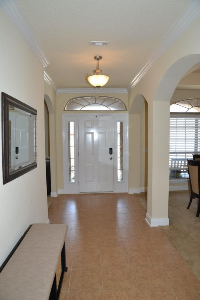 638 Red Fern Road Crestview, FL 32536 - Photo 9 of 55 a view of a hallway with wooden floor and a living room