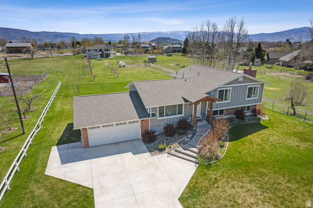 550 Pine Canyon Road Midway, UT 84049 - Photo 39 of 44 Split-level residence featuring a two-car garage, concrete driveway, and established front landscaping