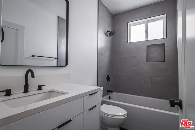 a bathroom with a sink a toilet and a bathtub