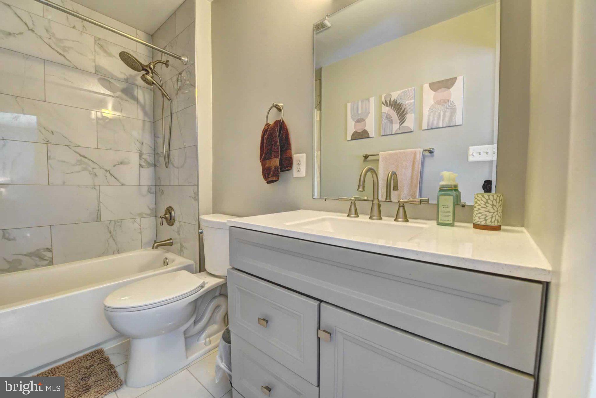2226 Gunsmith Square Reston, VA 20191 - Photo 24 of 35 a bathroom with a sink a toilet and shower