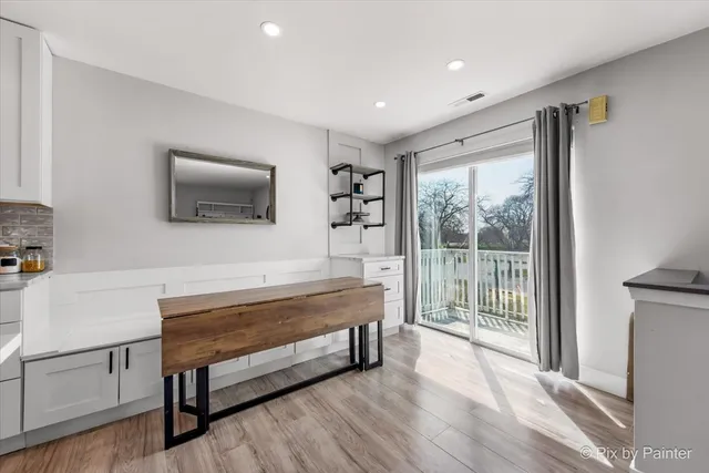 a living room with furniture a flat screen tv and a floor to ceiling window