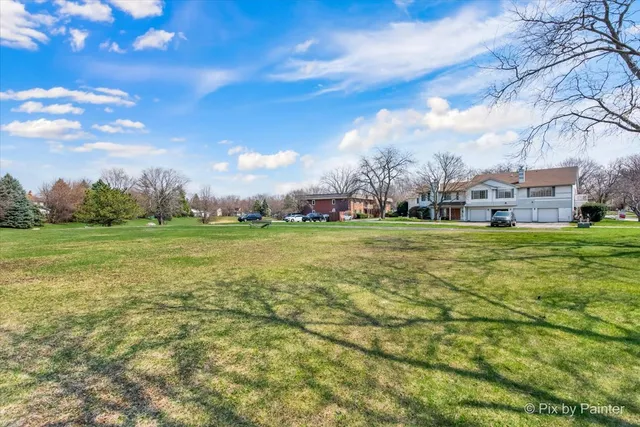 a view of a field with sitting area