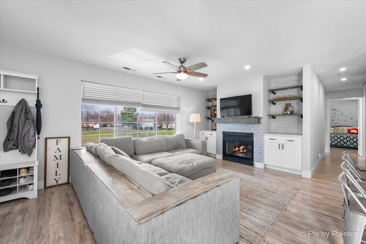 6-s018 Steeple Run Drive, Unit 6S018 Naperville, IL 60540 - Photo 2 of 22 a living room with furniture and a fireplace