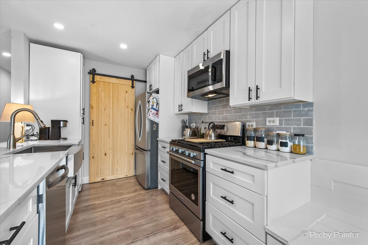 6-s018 Steeple Run Drive, Unit 6S018 Naperville, IL 60540 - Photo 8 of 22 a kitchen with stainless steel appliances granite countertop a stove a sink dishwasher and a refrigerator with wooden floor