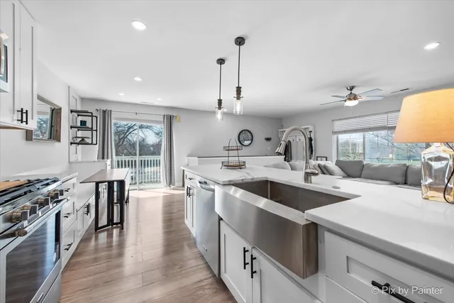 a kitchen with sink stove and wooden floor