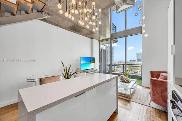 a living room with furniture and a floor to ceiling window