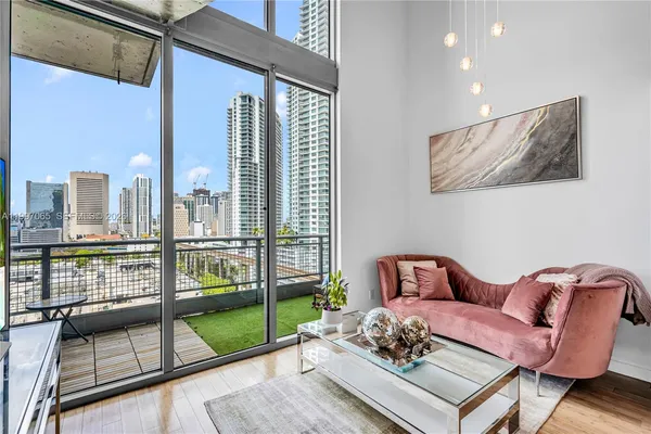 a living room with furniture tv and a large window