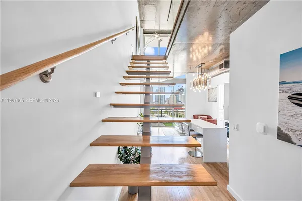 a large bed sitting in a balcony next to a window