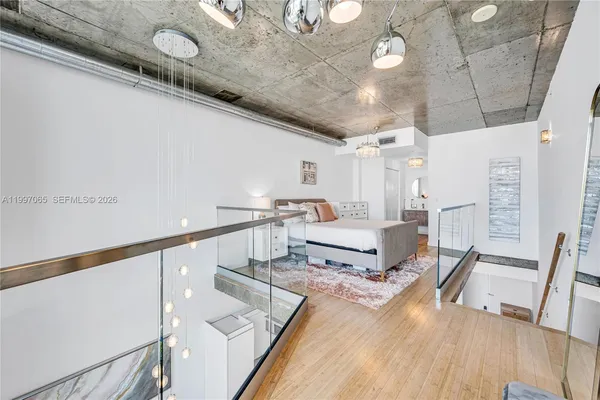 a living room with a bed furniture and a wooden floor