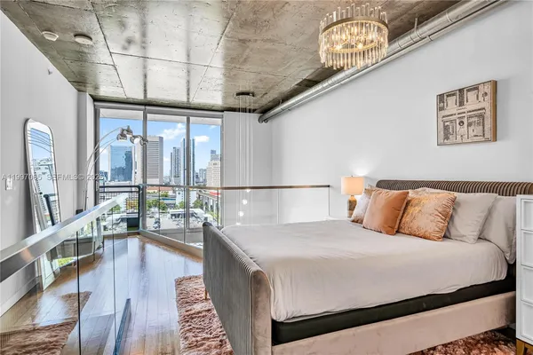 a bedroom with a large bed and a rug