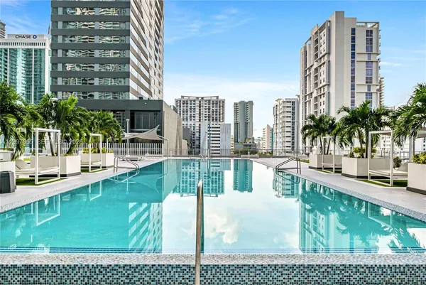 a lobby with furniture and floor to ceiling windows