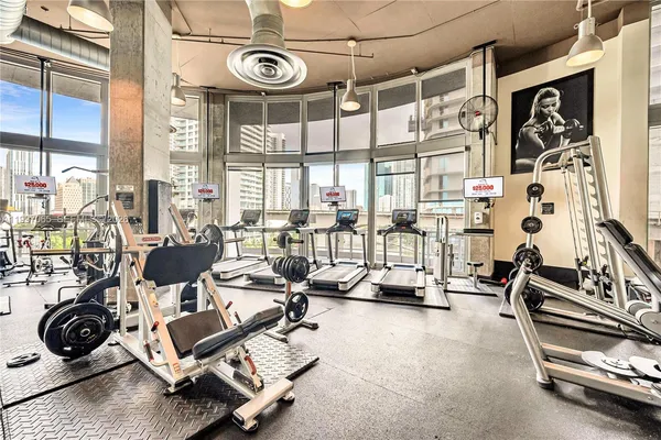 a front view of a building with a garden and plants