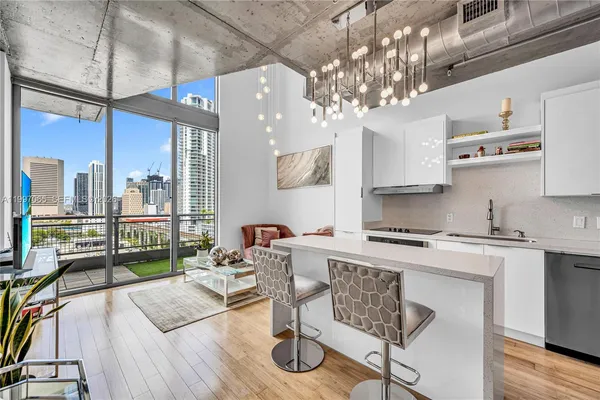 a kitchen with stainless steel appliances a sink a stove a refrigerator and cabinets