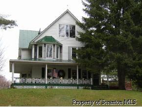 85 Rr 1 Springville, PA 18844 - Photo 1 of 6 a front view of a house with a garden