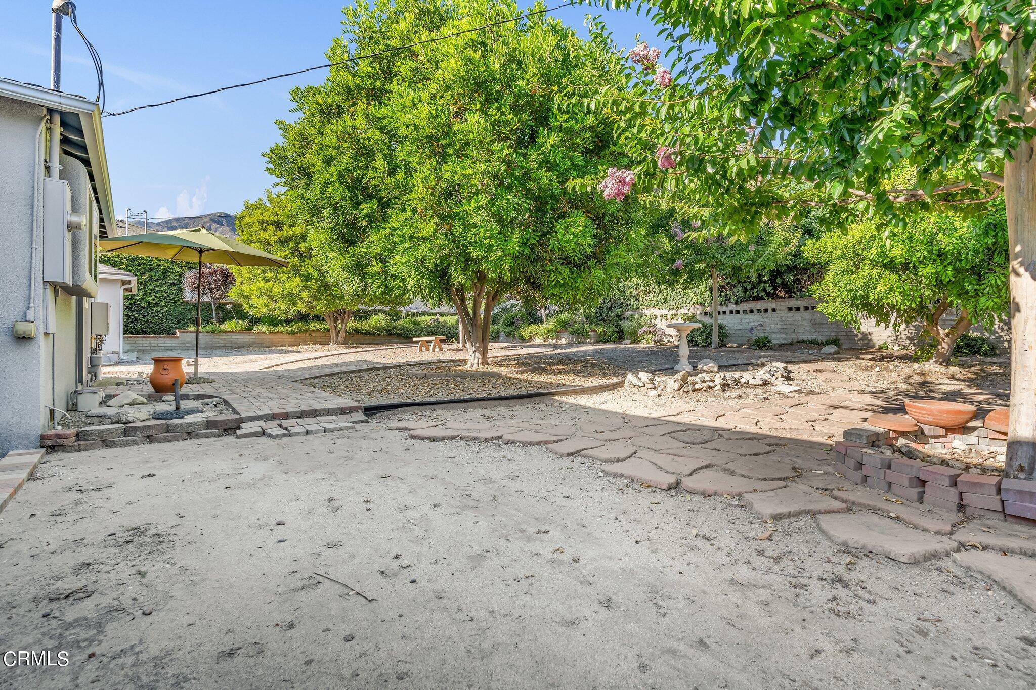 4632 Pennsylvania Avenue La Crescenta, CA 91214 - Photo 28 of 41 a backyard of a house with large trees and outdoor seating
