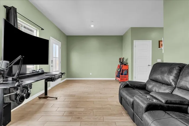 a kitchen with stainless steel appliances granite countertop a stove a sink a microwave a center island and furniture