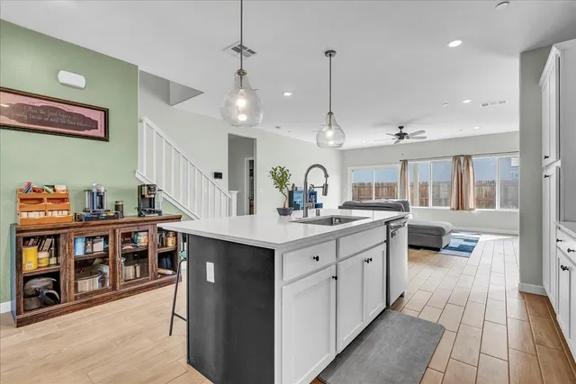 a living room with furniture and a ceiling fan
